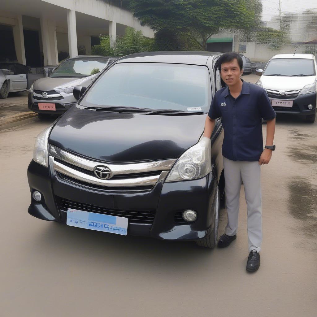 Khách hàng đang kiểm tra kỹ lưỡng tình trạng xe Avanza trước khi thuê.